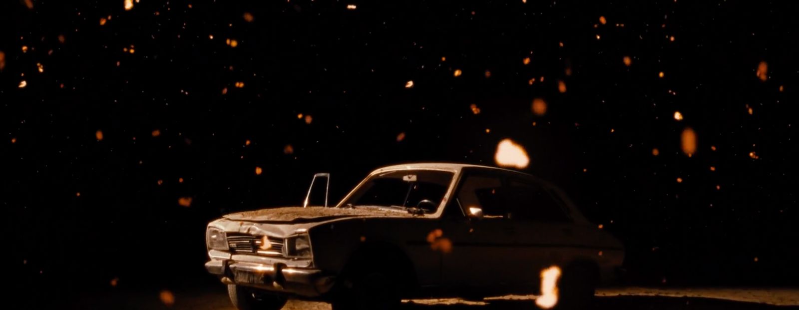 a truck parked in the dark on a snowy night