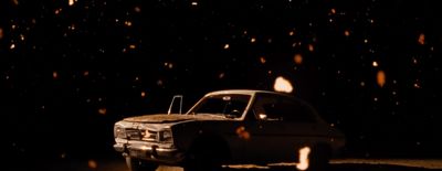 a truck parked in the dark on a snowy night