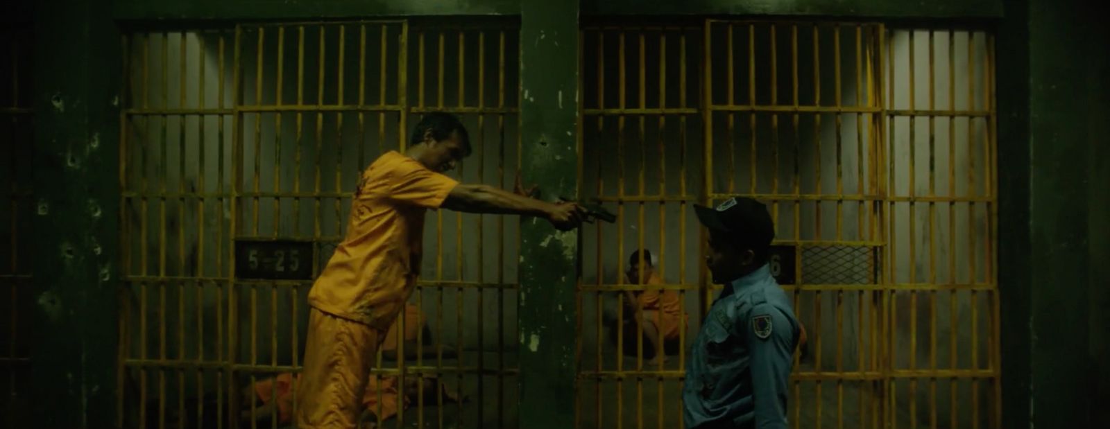 a man in a jail holding onto another man's hand