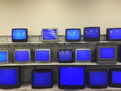 a bunch of tvs that are on a shelf