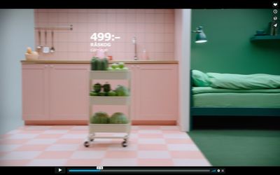 a pink and green room with a bed and a table