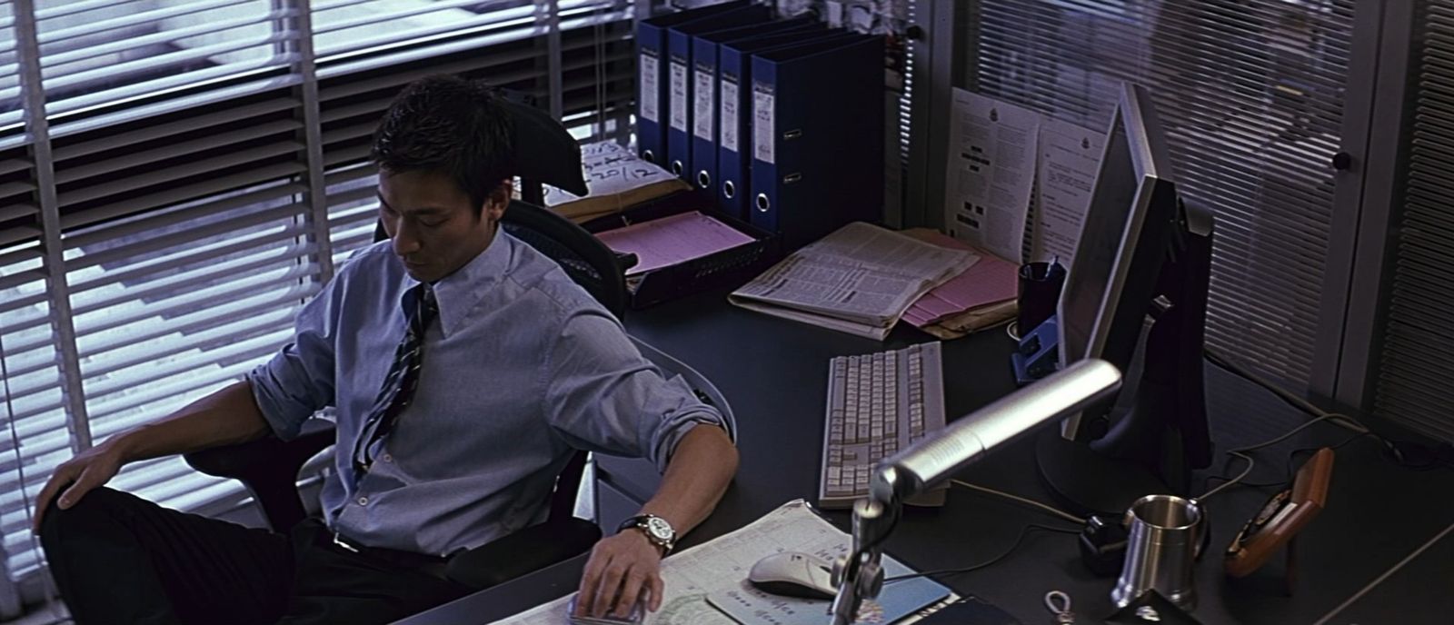 a man sitting at a desk working on a computer