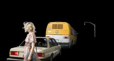 a woman standing next to a car and a bus