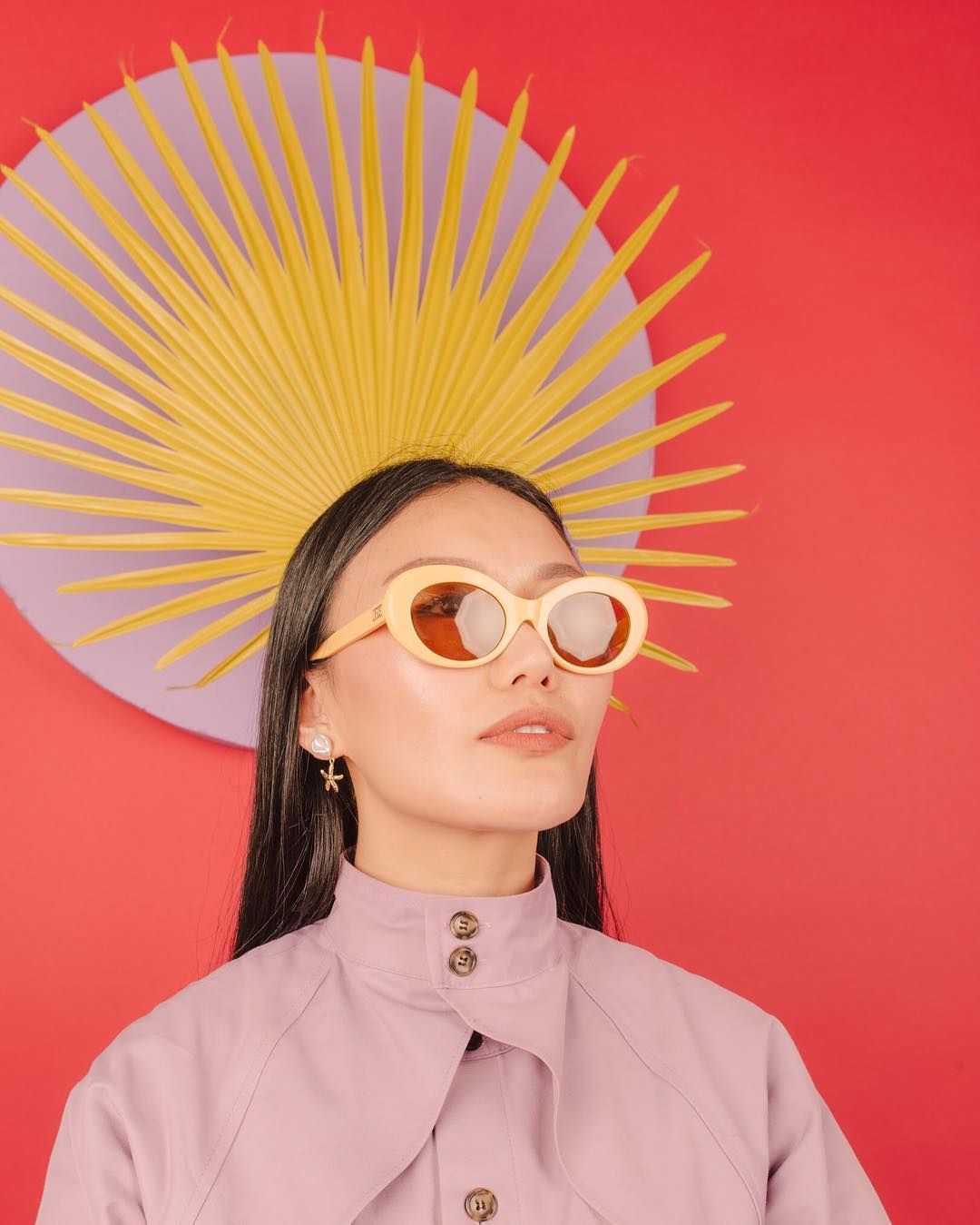 a woman wearing a yellow sun hat and sunglasses