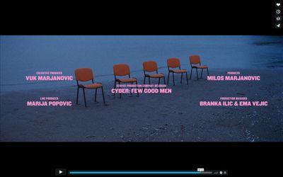 a group of chairs sitting on top of a sandy beach