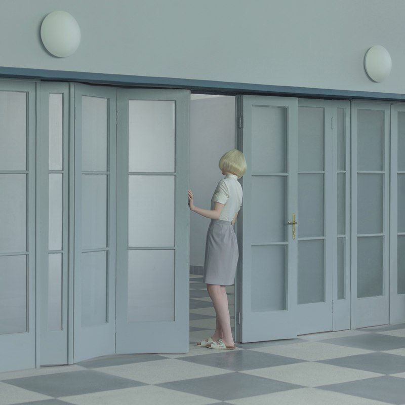 a woman standing in front of a door in a room