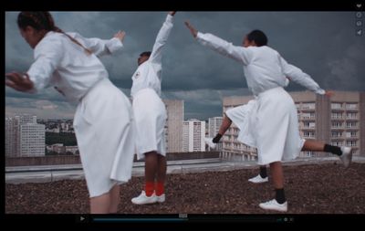 a group of people standing on top of a roof