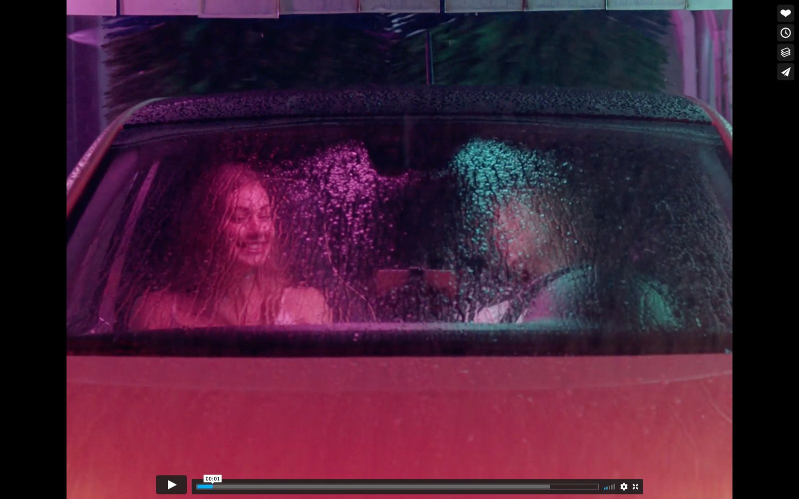 a man and a woman sitting in a car in the rain