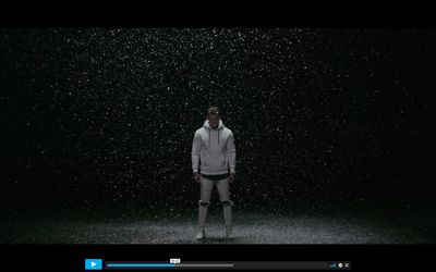 a man standing in the rain in the dark