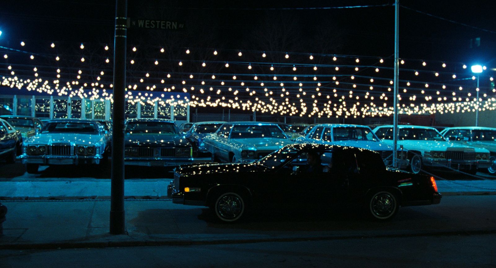 a car parked on the side of the road at night