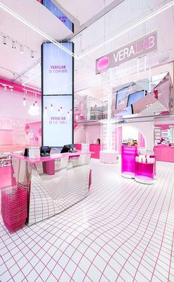 a pink and white store with a big screen