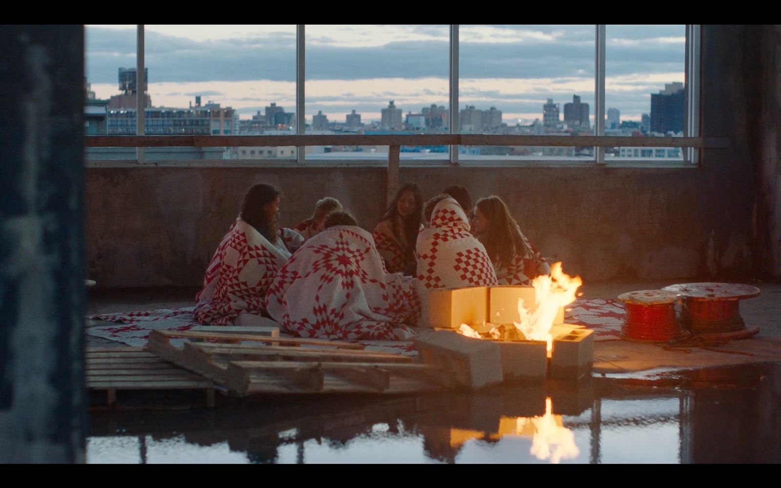 a group of people sitting around a fire pit