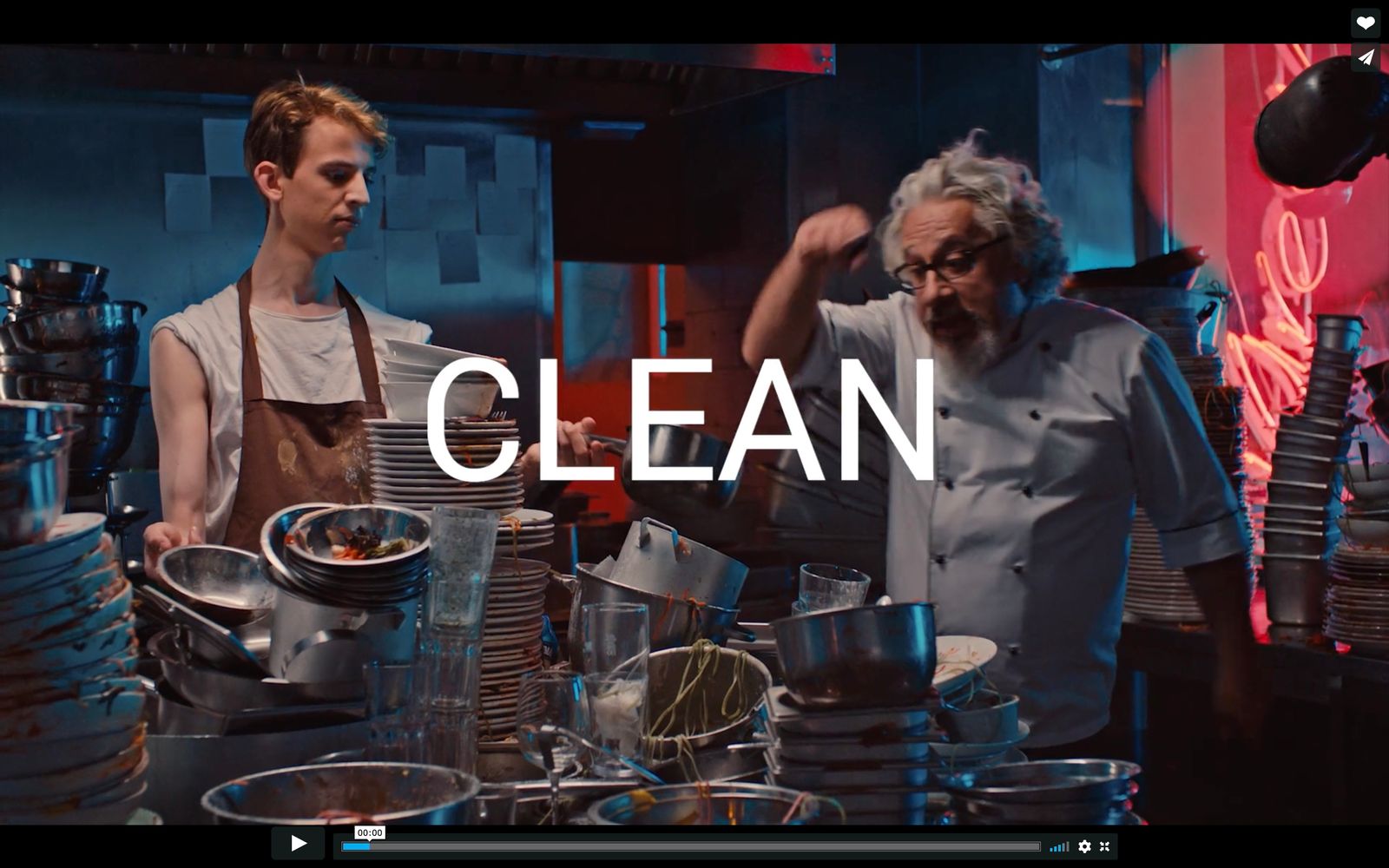 a man standing next to a woman in a kitchen