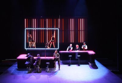 a group of people sitting on top of a stage