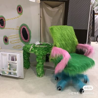 a green chair with pink and blue fur on it