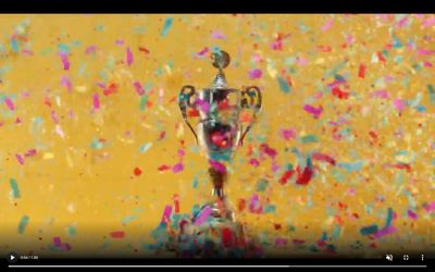 a silver trophy sitting on top of a table covered in confetti