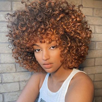 a close up of a person with curly hair