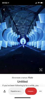 a man standing in a tunnel of blue lights