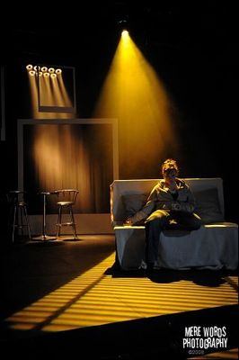 a man sitting on a couch in a dark room