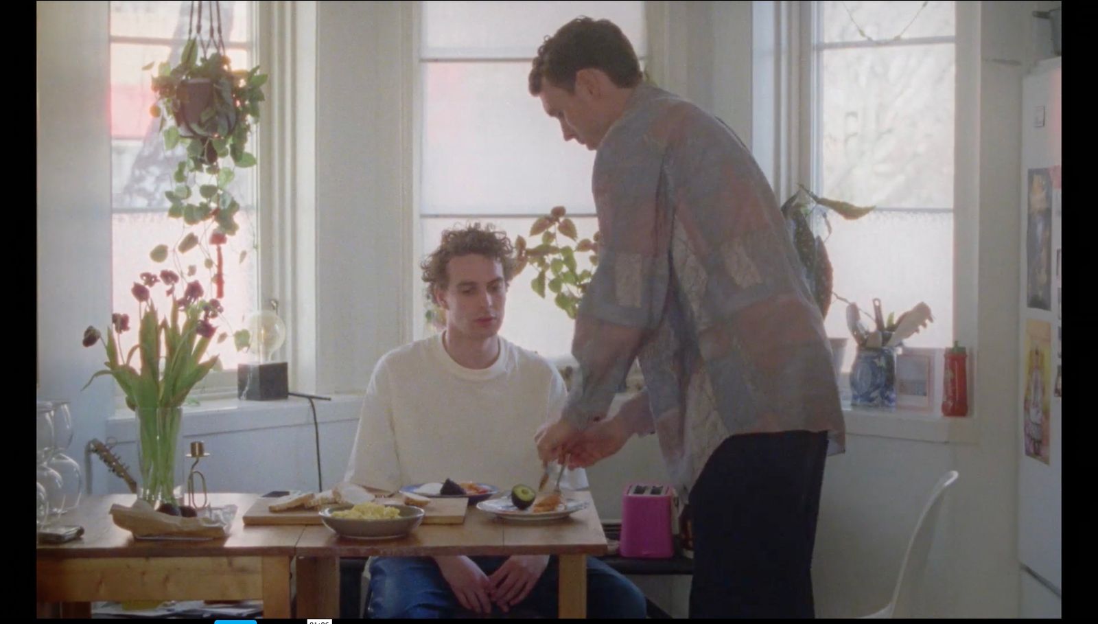 a man standing over a table with a plate of food