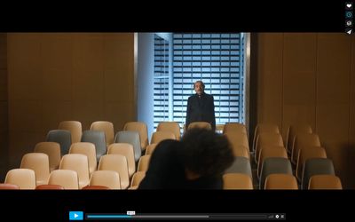 a man standing in front of a row of chairs