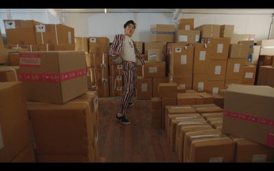 a man standing in a room full of boxes