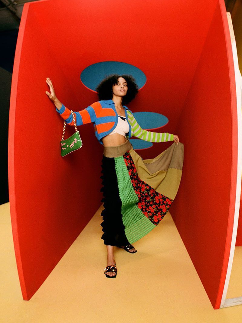 a woman is posing in a red sculpture