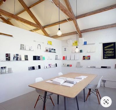 a room with a wooden table and white chairs