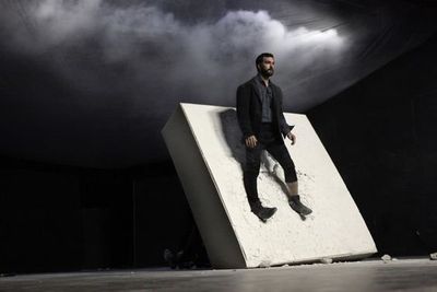 a man standing on top of a block of concrete