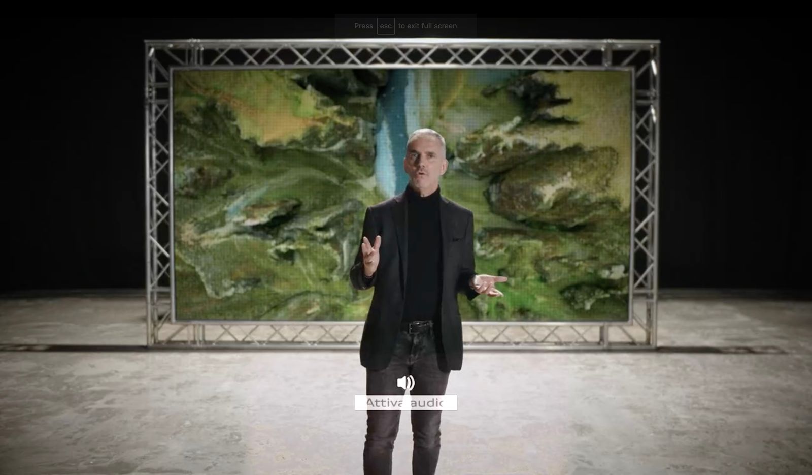 a man is standing in front of a painting