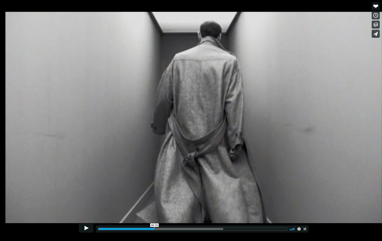 a man in a robe walking down a hallway