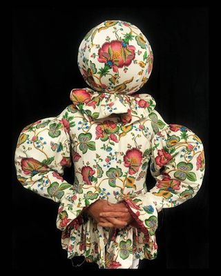 a woman wearing a floral print jacket with a hood