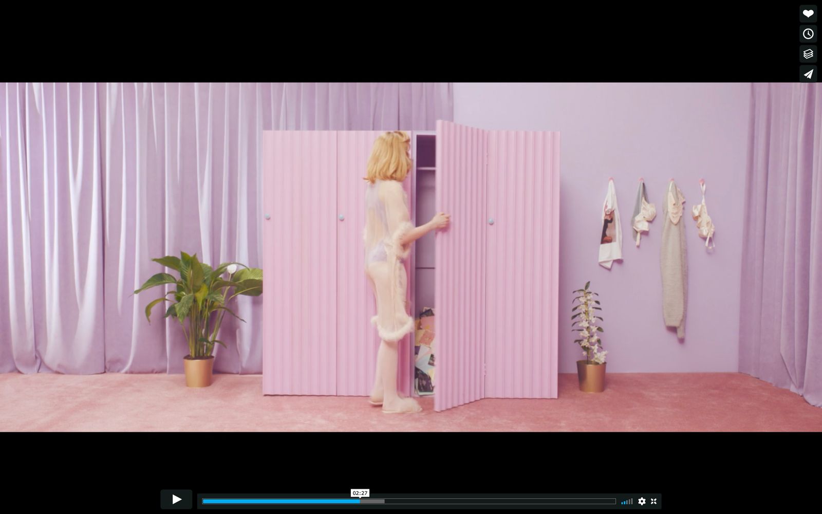 a woman standing in front of a pink closet