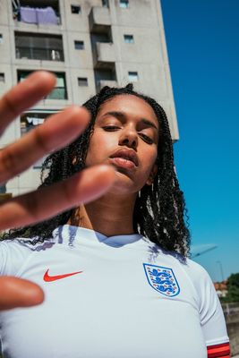 a woman in a white shirt holding out her hand