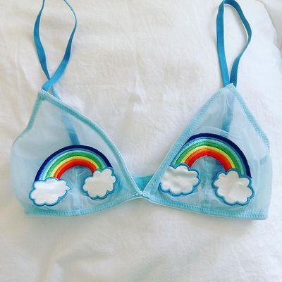 a bikini top with a rainbow and clouds on it