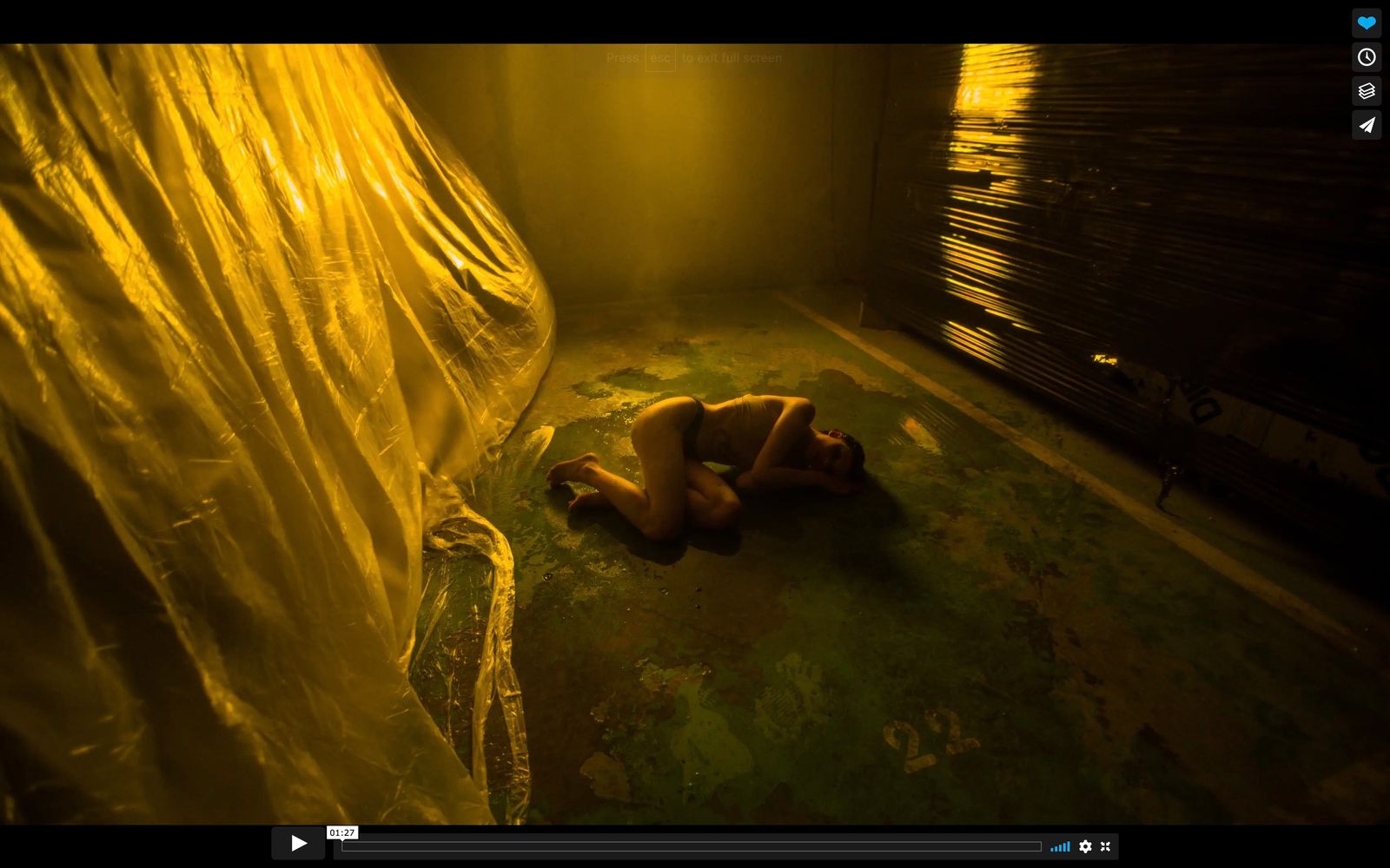 a naked woman laying on the floor in a room
