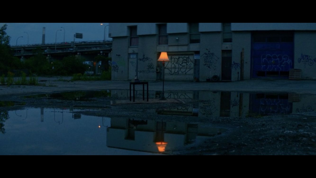 a reflection of a building in a puddle of water