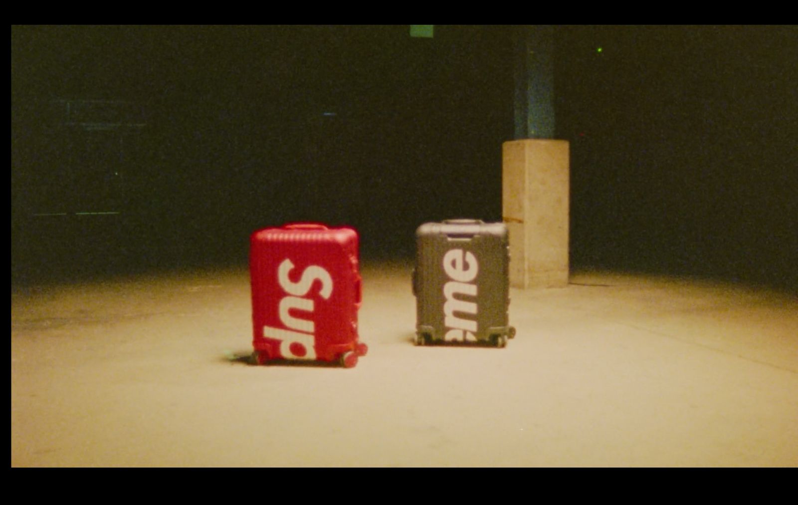 two suitcases sitting next to each other on the ground