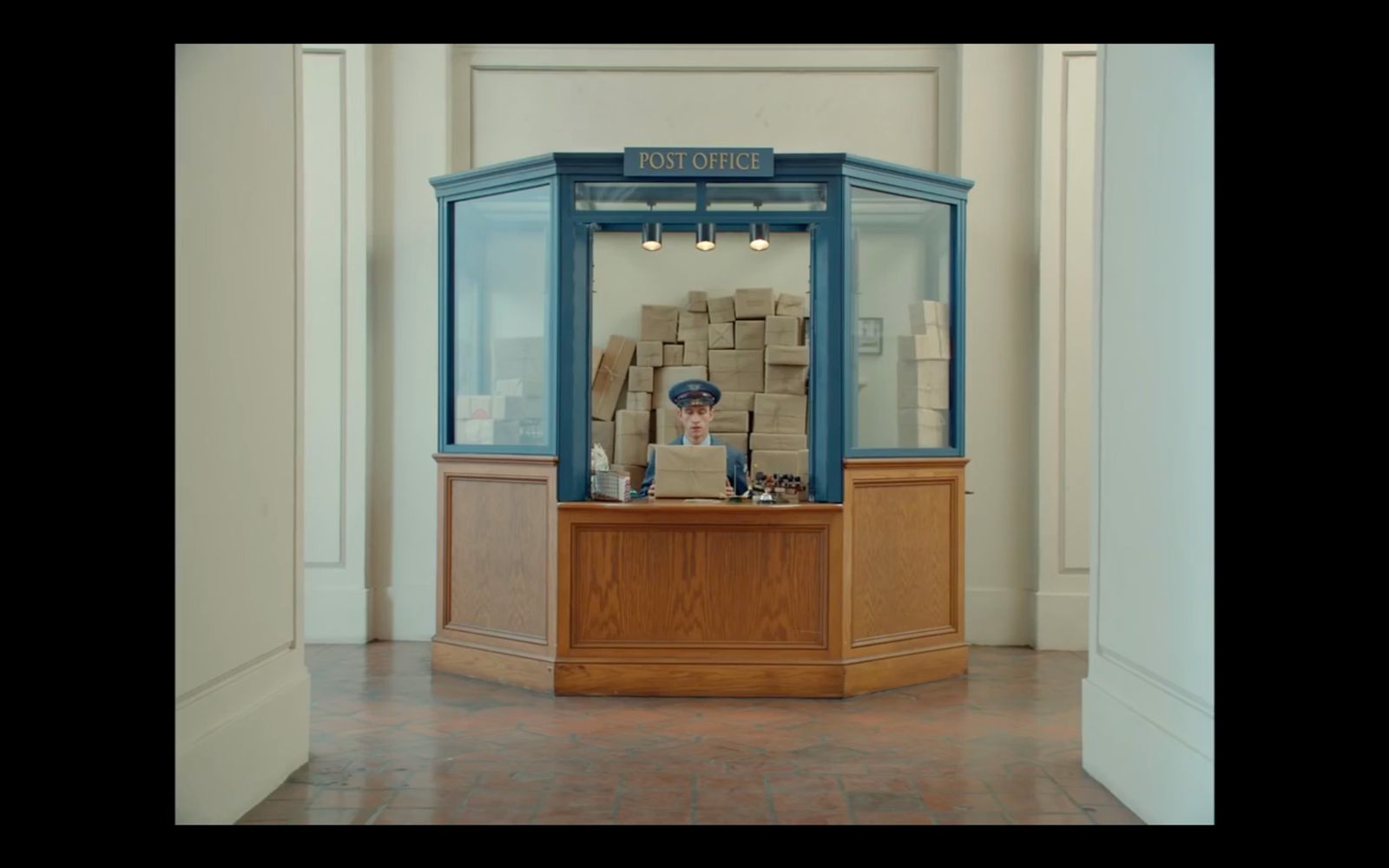 a man sitting at a desk in a room