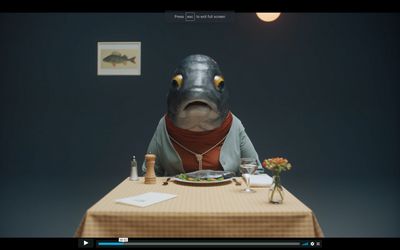 a man sitting at a table with a plate of food in front of him