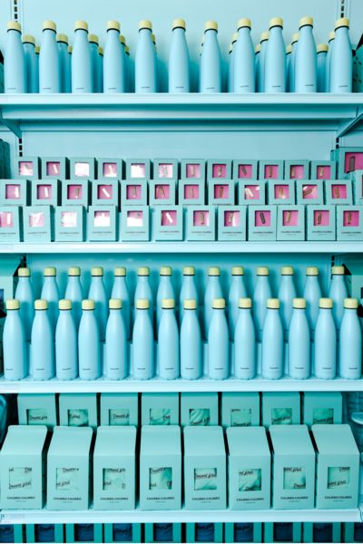 a shelf filled with lots of blue bottles