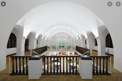 a large white building with a wooden staircase