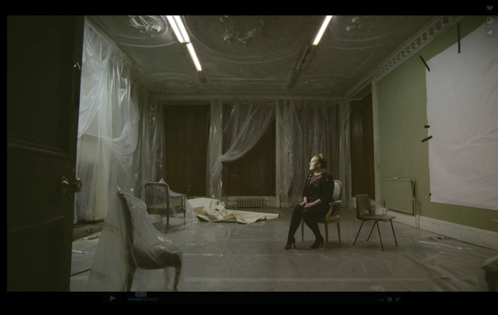 a woman sitting on a chair in a room