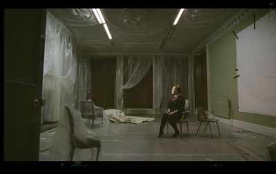 a woman sitting on a chair in a room