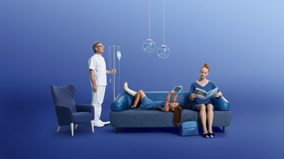 a woman sitting on a blue couch next to a man