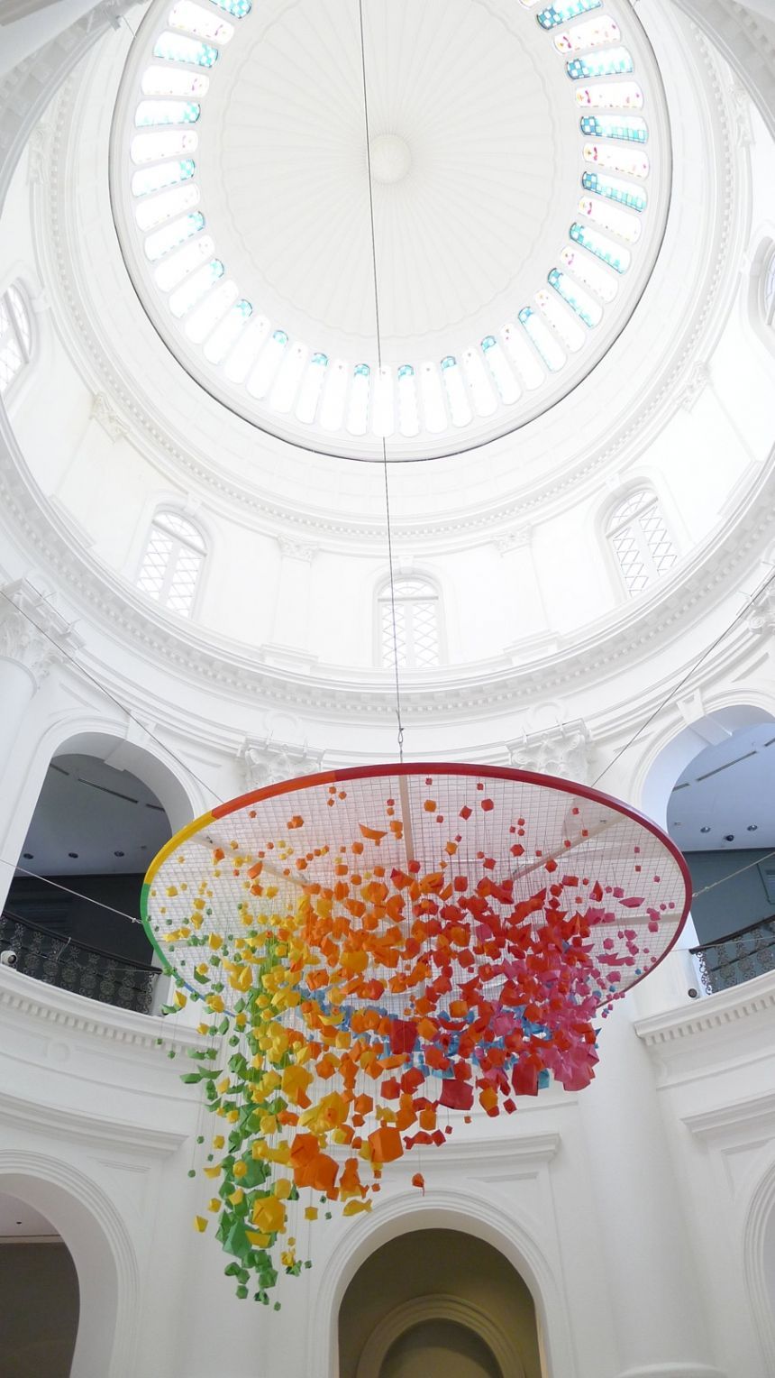 a large glass sculpture hanging from the ceiling of a building