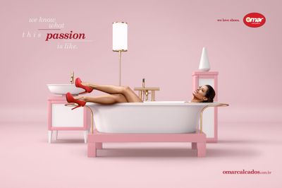 a woman laying in a bathtub with red high heels