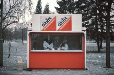 a red and white stand with two people in it