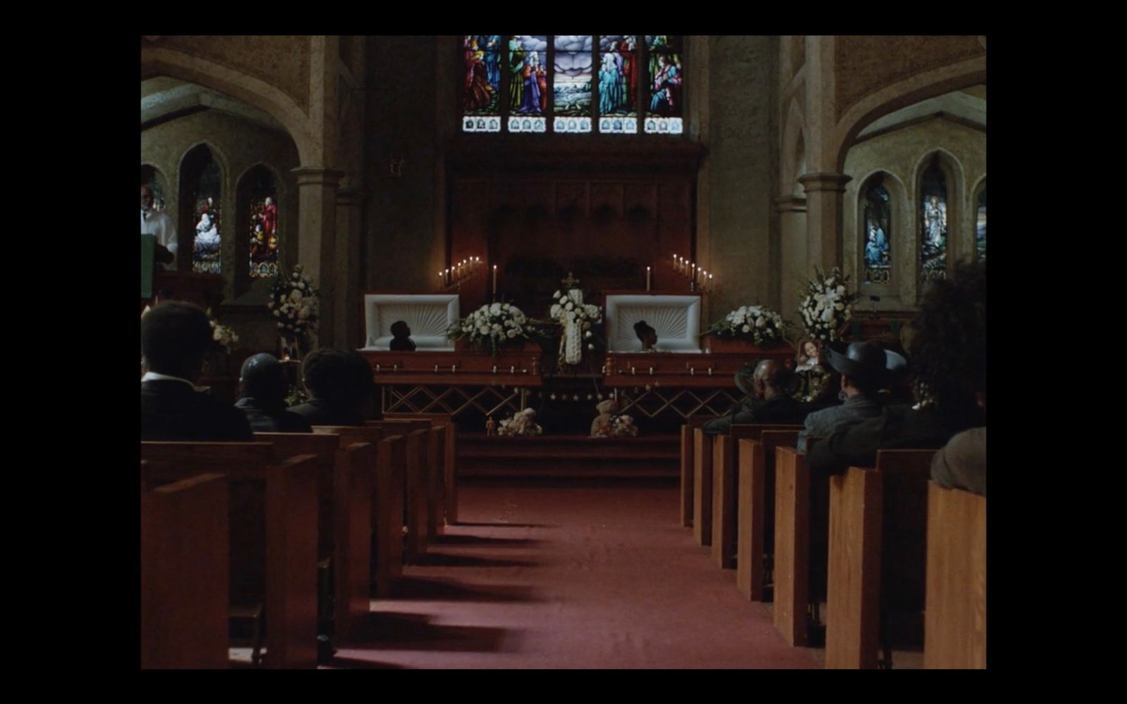 a group of people sitting in pews in a church