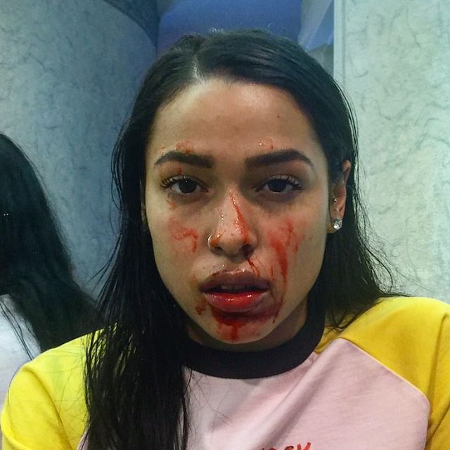 a woman with blood all over her face